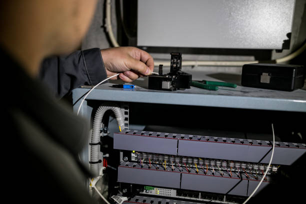 istock The technician attaching fiber optic on the Optical Distribution Frame. Man working in network server room with fiber optic hub for digital communications and internet. 1175275668