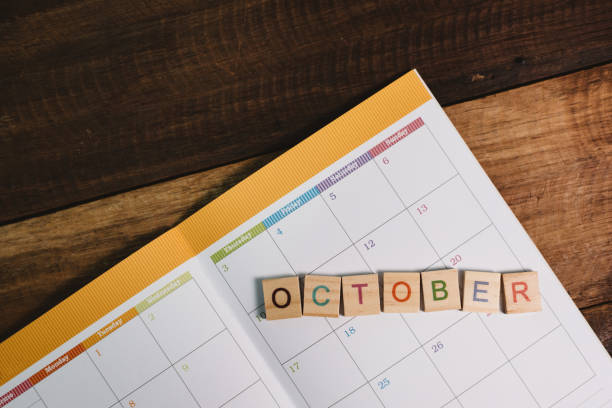 istock Close-Up Of October Text On Open Book 1175275728
