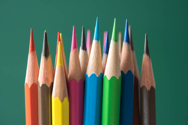 istock Close-Up Of Multi Colored Pencils Against Green Background 1175277465