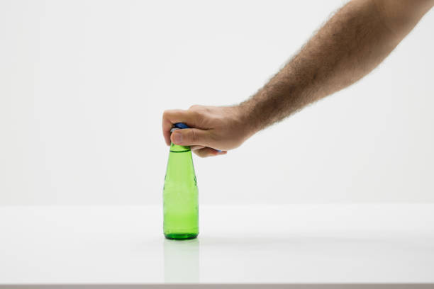 Man is opening bottle of soda water.
