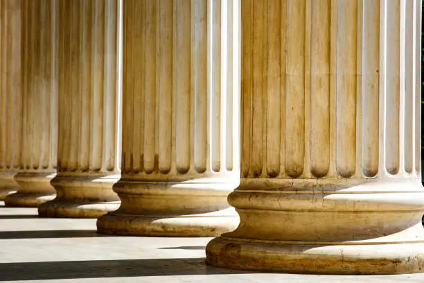 Photo of Columns with base and flute on a sun light