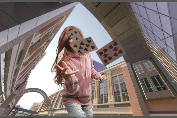 Woman throwing cards over camera