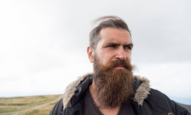 istock bearded handsome serious man on mountain top 1175284540