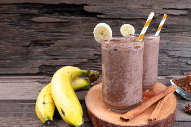 istock Banana blended chocolate yogurt smoothies milk high protein drinks brown put a glass on a wooden background. 1175285465