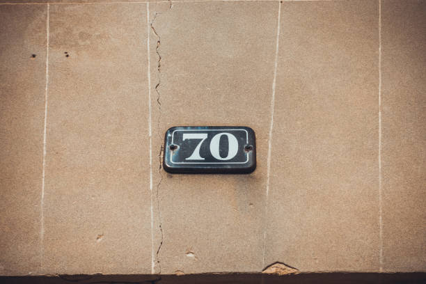 istock number 70 door sign on brown background 1175286161
