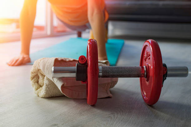 istock dumbells with girl doing sport 1175286390