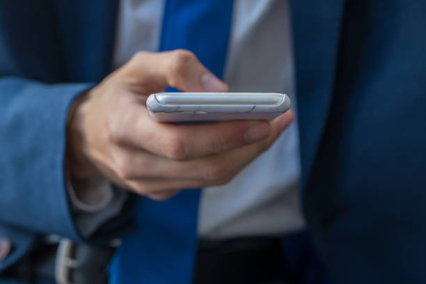 istock business man closeup with mobile phone 1175286439