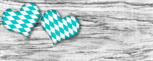 blue Beer Fest Dirndl with red white heart on wooden background. heart made of birch tree wood und cotton.