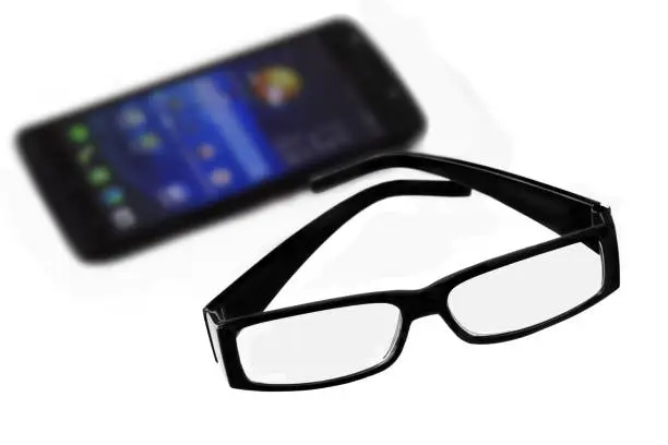 Mobile and glasses close up