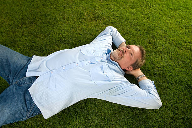 istock Mature man lying on the grass 117529026