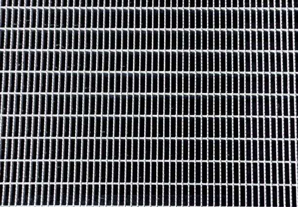 istock metal grid background on pavement on the street 1175292678