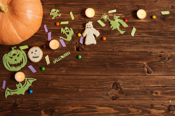 istock Halloween holiday background with pumpkin and candy. View from above 1175292894