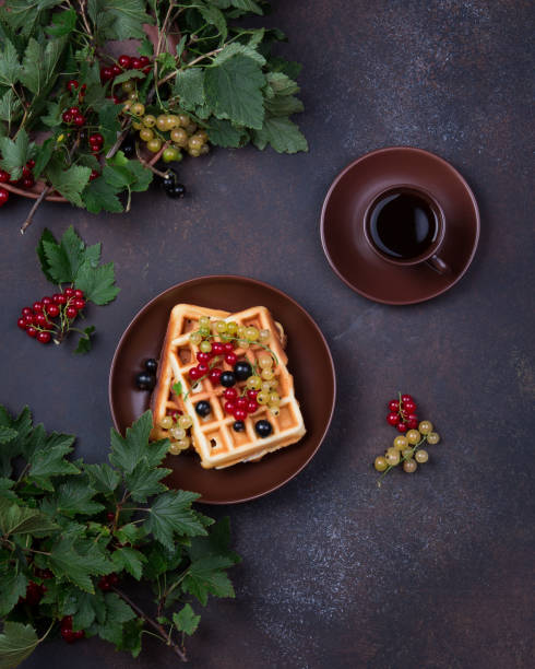 istock Plate of belgian waffles with currant berries on dark gray background. From top view 1175295820