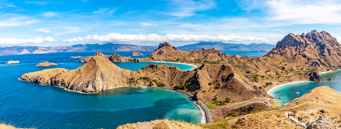 This pic shows Mountain range in Komodo National Park in Indonesia. The pic shows Beautiful panorama view of the island with mountain and blue ocean. The pic is taken in day time in july 2018.