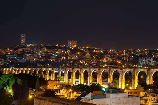 Cityscape of Queretaro city at night with its famous Viaduct, Mexico.