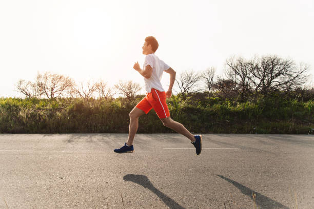 istock Young Male Runner Running On Rural Road 1175297123