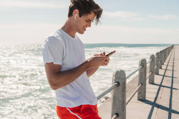istock Young Man Choosing Is Favorite Workout Music 1175297201