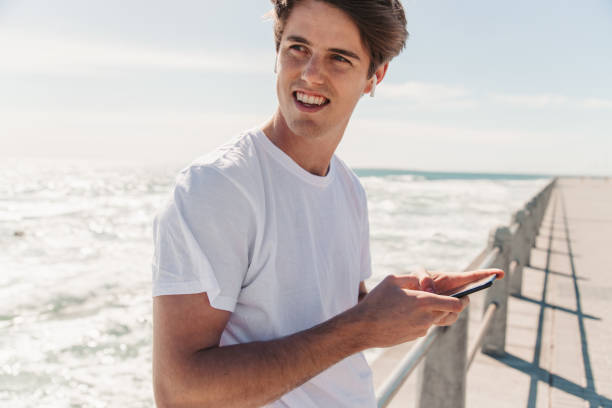 istock Young Man Choosing Is Favorite Workout Music 1175297208
