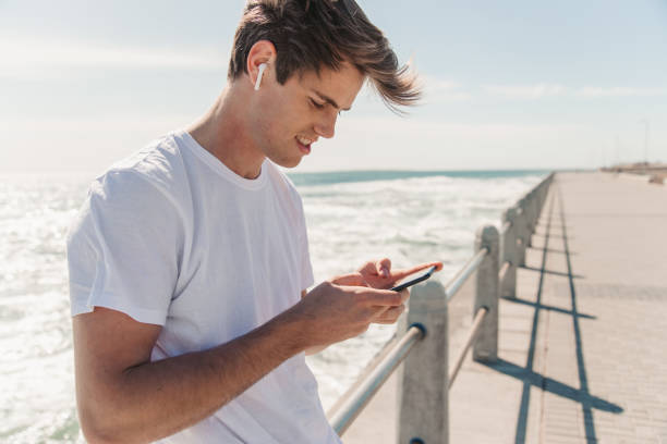 istock Young Man Choosing Is Favorite Workout Music 1175297222