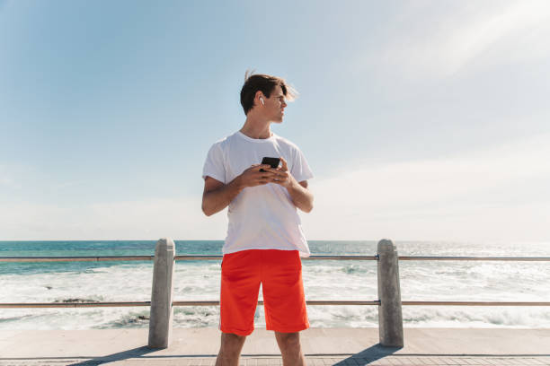 istock Young Man Choosing Is Favorite Workout Music 1175297267