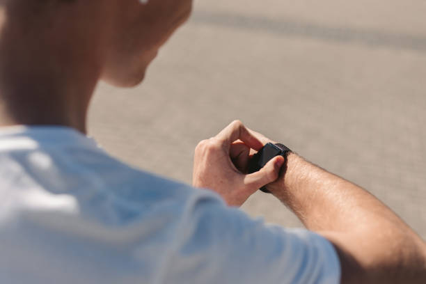 istock Young Male Athlete Checking His Smart Watch 1175297297