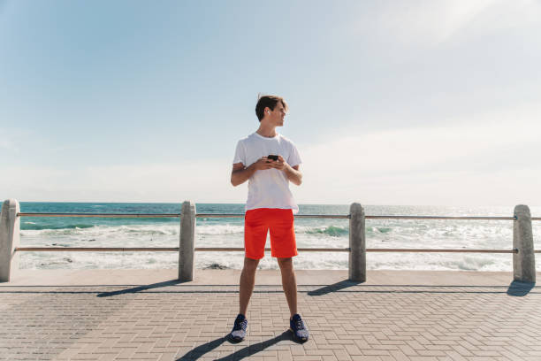 istock Young Man Choosing Is Favorite Workout Music 1175297313