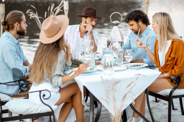 istock Friends having a festive dinner near the lake 1175297323