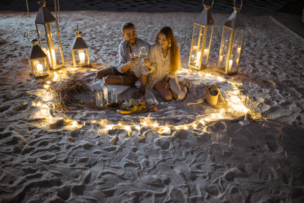 istock Couple on a romantic dinner on the beach at dusk 1175298315