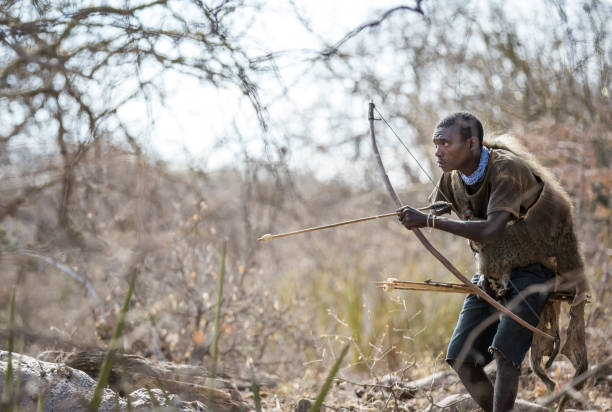 Lake Eyasi, Tanzania, 11th September 2019: Hadzabe hunter hunting for birds in the nature of northern Tanzania
