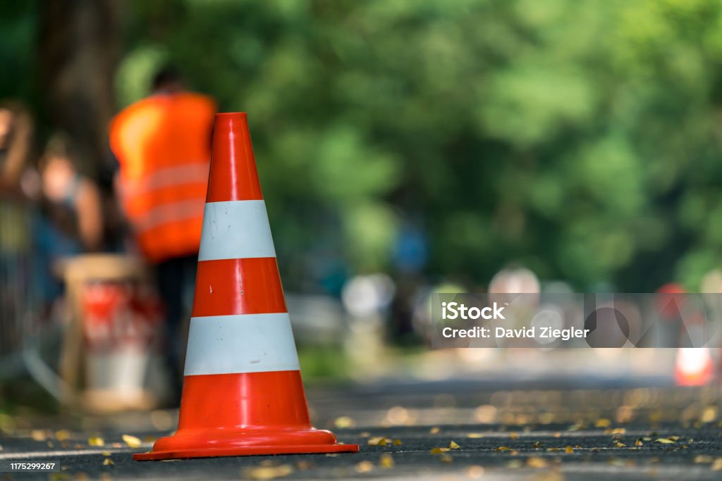 Traffic cone Traffic cone on a street as a warning sign Road Construction Stock Photo