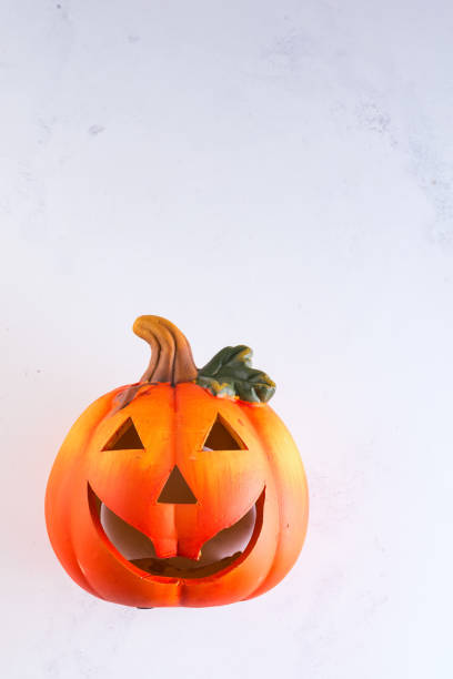 istock Halloween Pumpkin, funny Jack O'Lantern on white murble background, copy space 1175300957