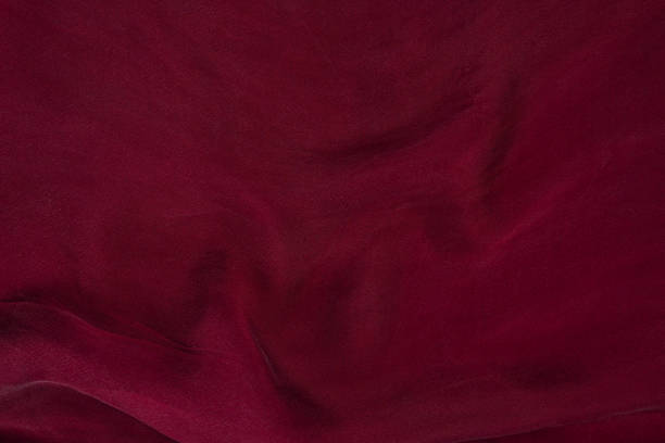 istock Soft smooth burgundy silk fabric background. Fabric texture. 1175301118