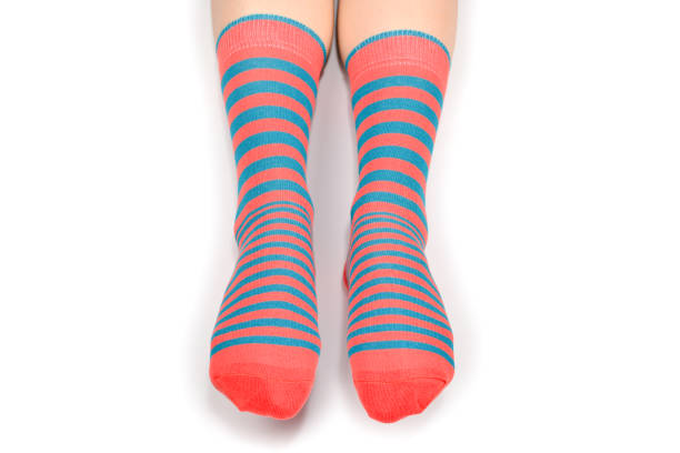 istock Woman in orange socks isolated on white background. Top view. 1175302554
