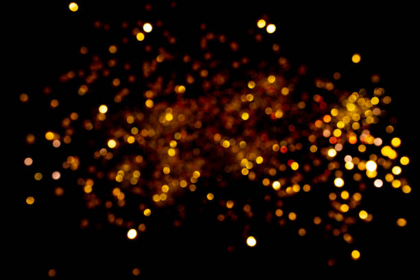 istock beautiful blurred golden background on black 1175304904