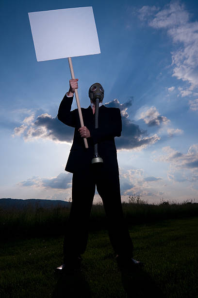 istock Man in gas-mask with placard 117530503