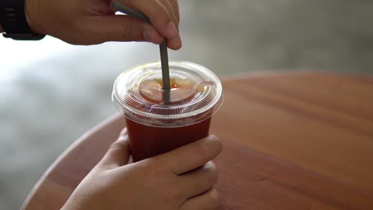 Hand Stirring tasty ice coffee.