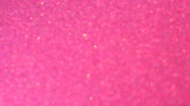 istock Loop-able abstract glowing gold bokeh sparkling on pink old rose background. 1175309521