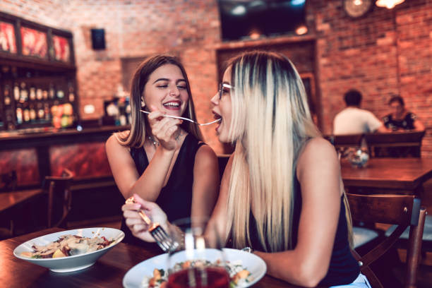 istock Females Feeding Each Other In Luxurious Restaurant 1175309530