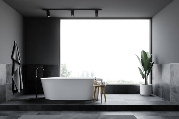 istock Gray and tiled loft bathroom interior, tub 1175309570
