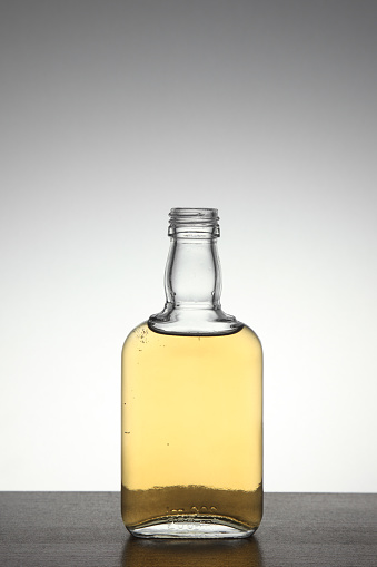 Front view of backlit whisky bottle