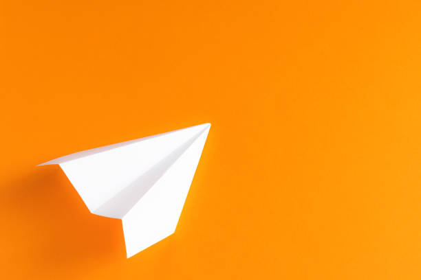 istock white paper plane on an orange background 1175311995