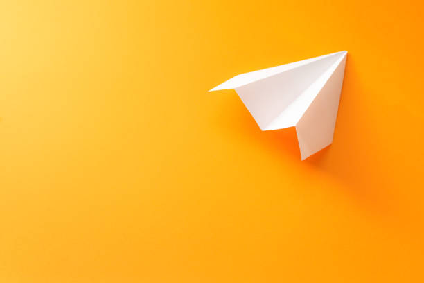 istock white paper plane on an orange background 1175312033