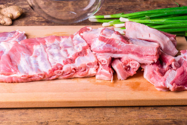 istock Raw chopped pork ribs on a wooden cutting board 1175313226