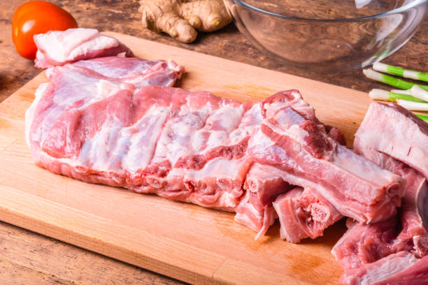 istock Raw chopped pork ribs on a wooden cutting board 1175313305
