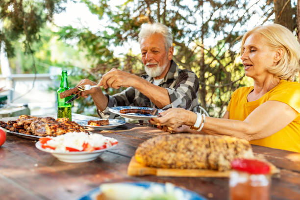 istock Senior couple having lunch outdoors 1175315029