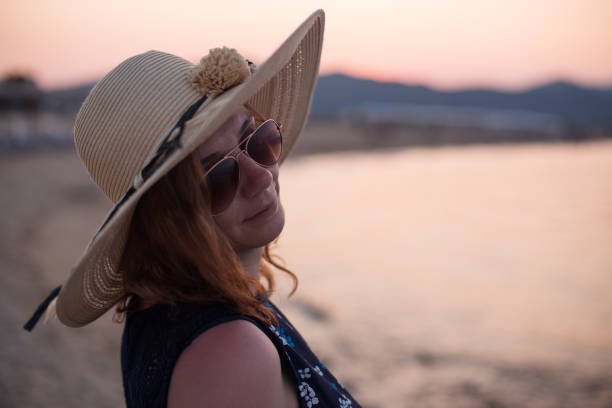 istock Young woman enjoying sunset on a beach 1175317640