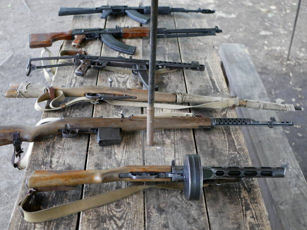 istock Samples of Soviet automatic weapons of the second world war. Machine guns and machine guns on a wooden table outside on a summer day. 1175319072