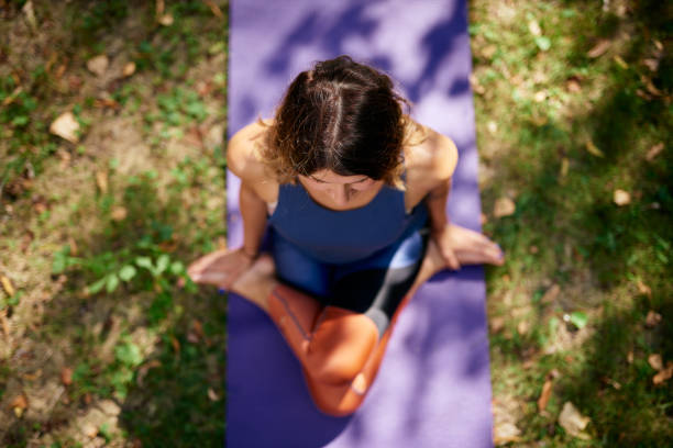 istock Woman practicing yoga in park. 1175320620