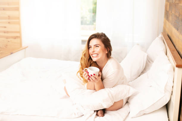 istock Happy ginger girl smiling, relaxing in bed. 1175321061