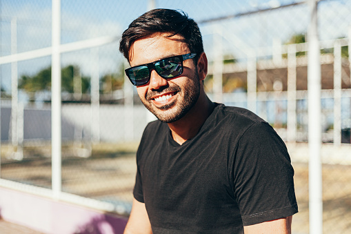 Outdoor portrait of man wearing t-shirt and sunglasses